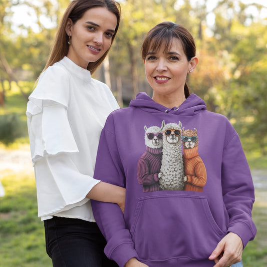 Two women standing outdoors, one wearing a purple hoodie with alpaca design.