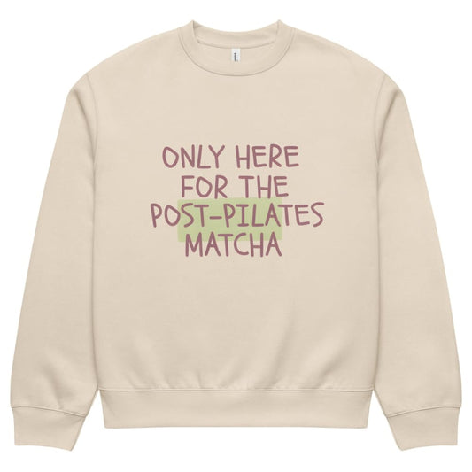 Beige sweatshirt with text 'Only here for the post-pilates matcha' on a white background
