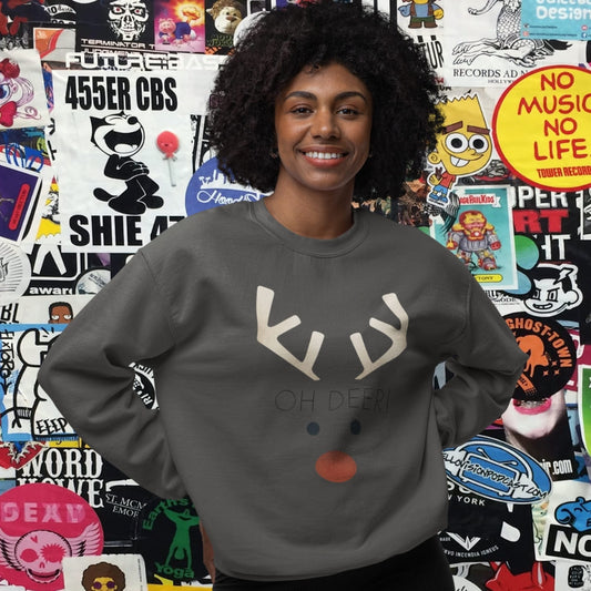 Person wearing a gray sweatshirt with a reindeer design in front of a colorful wall of stickers.