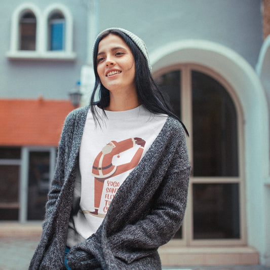 Woman wearing a graphic t-shirt with a life buoy design outdoors.