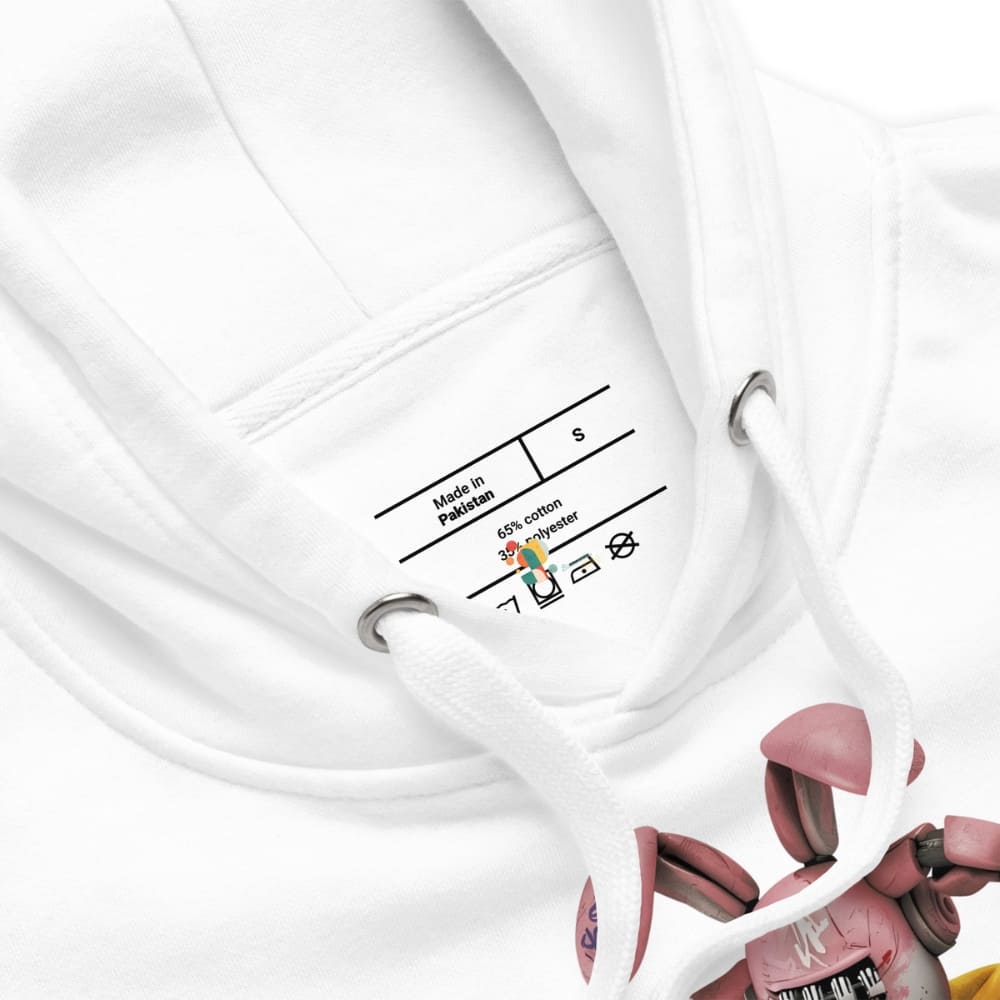 Close-up of a white garment with a label and pink shoes in the background