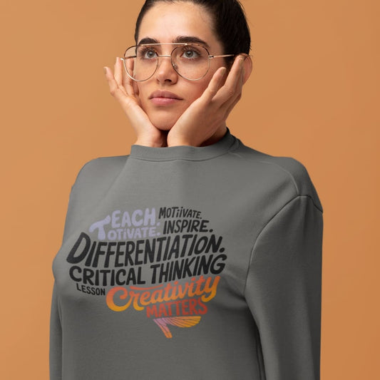 Person wearing a gray sweatshirt with motivational text on an orange background