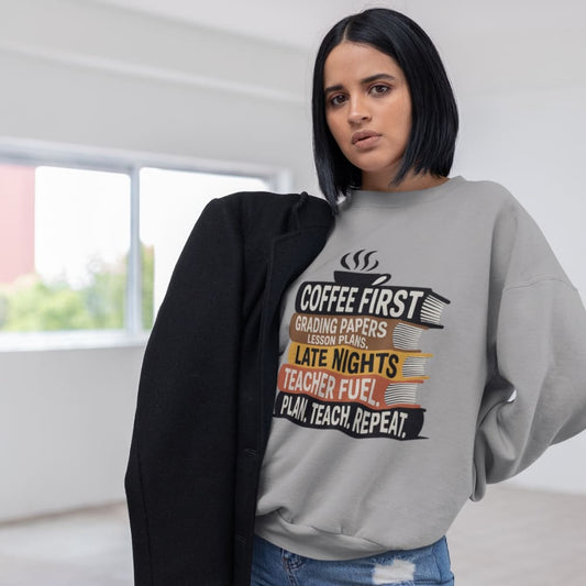 Woman wearing a gray sweatshirt with a humorous teacher design.
