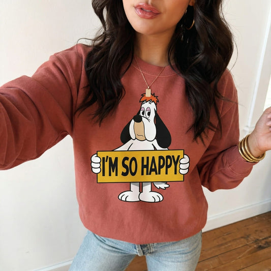 Person wearing a red sweatshirt with a cartoon dog holding 'I'm So Happy' sign.