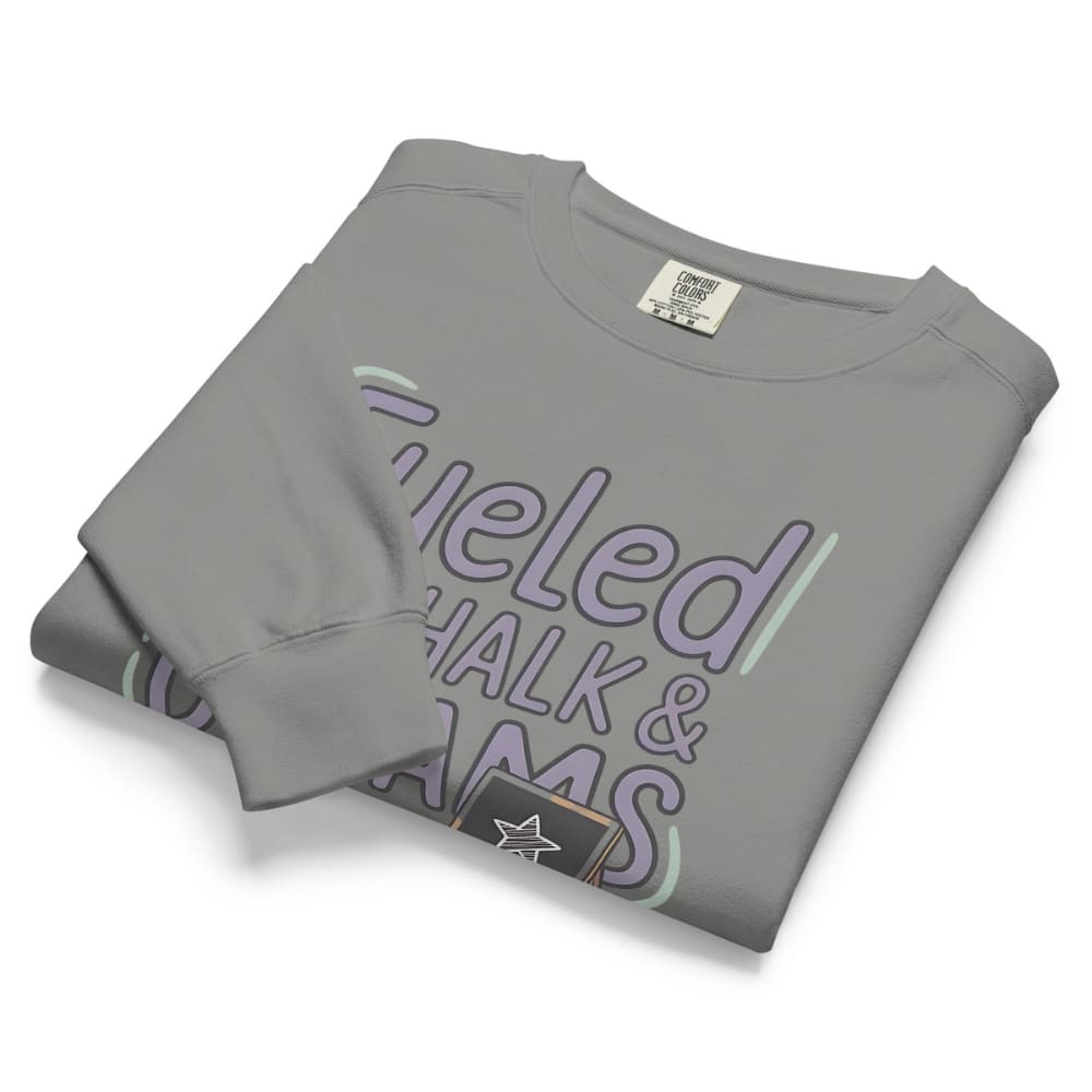 Fueled by Chalk & Dreams printed design on a vintage-style garment-dyed sweatshirt with chalkboard illustration – soft fleece ideal for teachers
