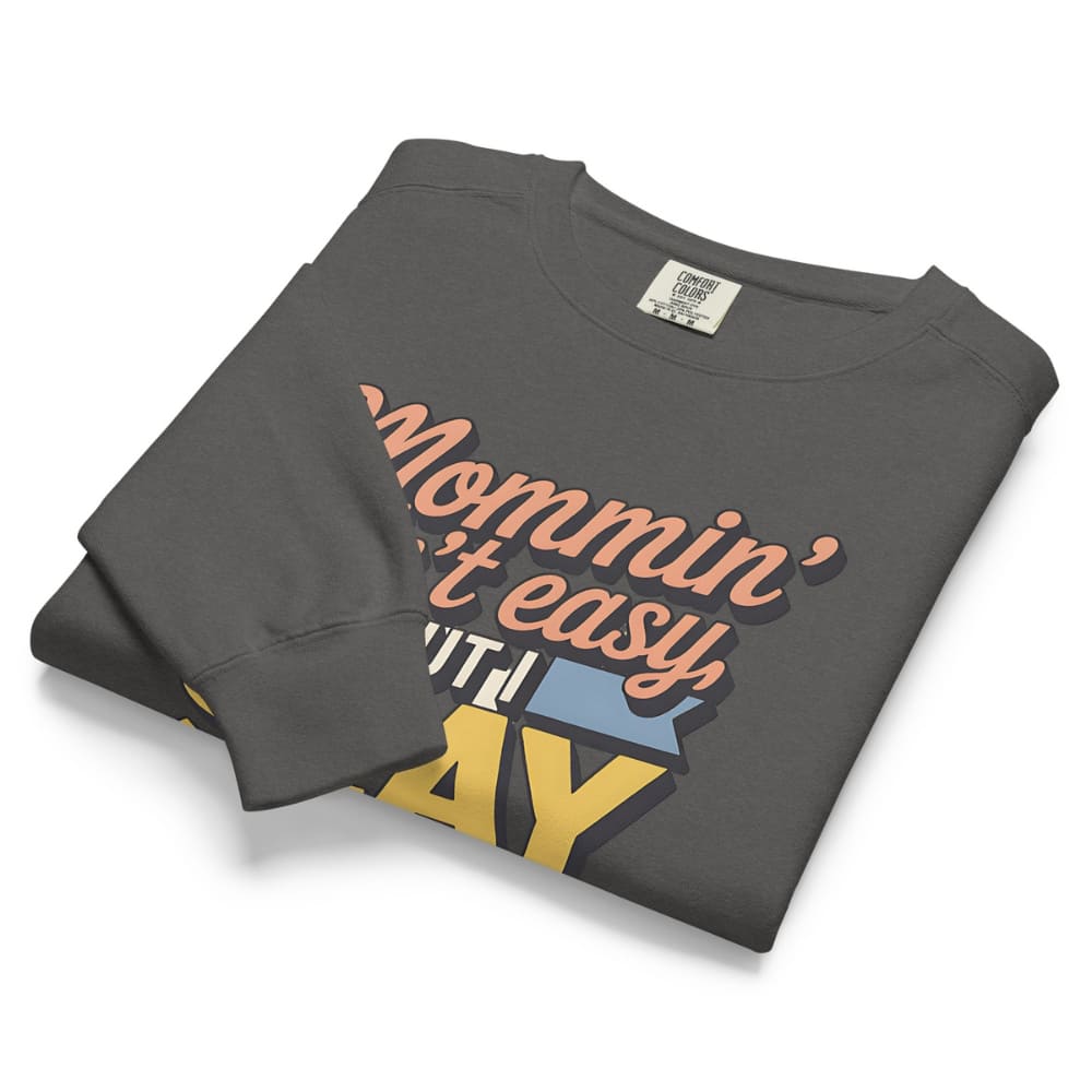“Mommin' Ain’t Easy But I Slay” retro-style DTG printed design in peach, blue, and yellow on vintage garment-dyed fleece sweatshirt