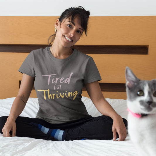 Garment-dyed relaxed fit t-shirt with motivational quote “Tired But Thriving” in modern handwritten script