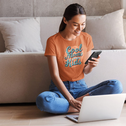 Graphic t-shirt with text “Cool Moms Raise Cool Kids” in bold vintage font – fun parenting design on soft garment-dyed cotton tee