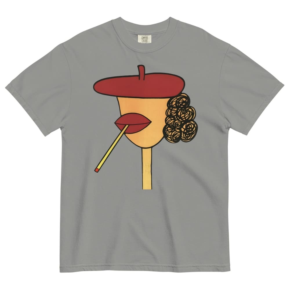 Gray t-shirt with a stylized face design featuring a red beret, yellow face, red lips, and black hair on a white background.