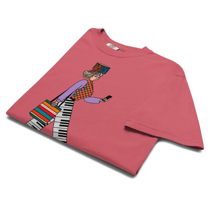 Watermelon red t-shirt with a colorful graphic of a person playing a keyboard on a white background