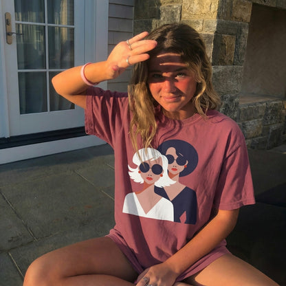 Person wearing a pink t-shirt with graphic design outdoors