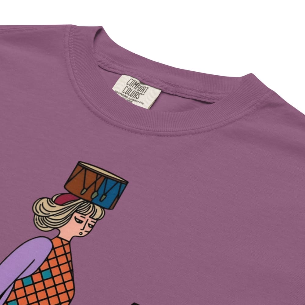 Berry purple t-shirt with a graphic of a person holding a drum on their head, featuring 'Comfort Colors' label.