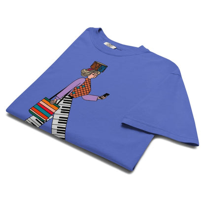 Flo blue t-shirt with a colorful graphic of a person playing a keyboard on a white background