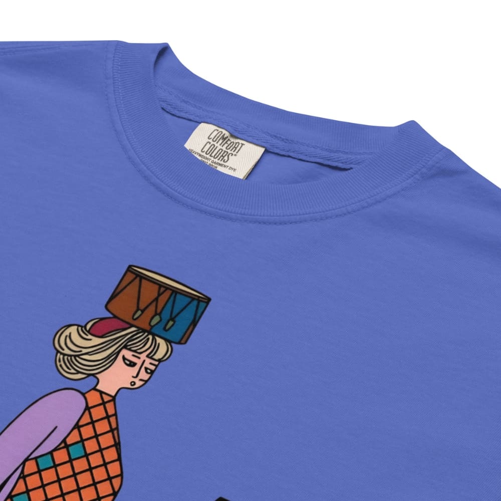 Flo blue t-shirt with a colorful graphic of a person holding a drum on a white background