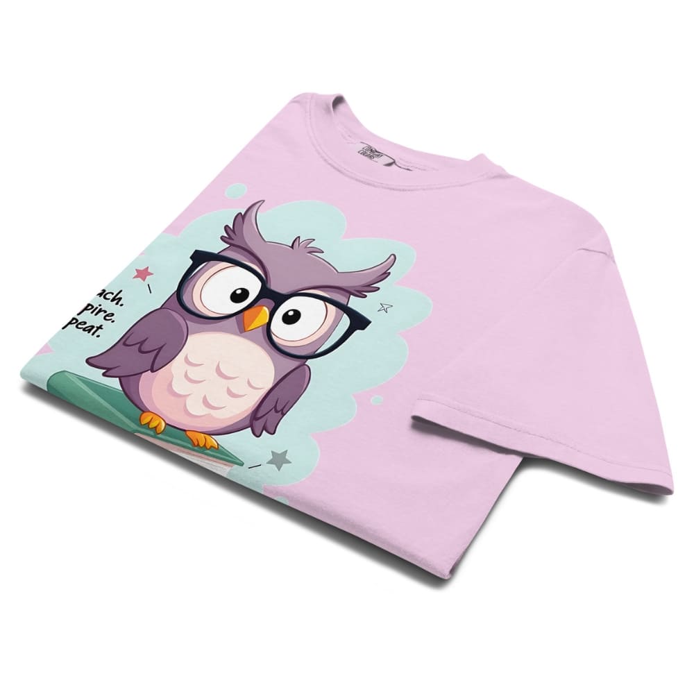 Cute purple owl with glasses sitting on stacked books, with quote "Teach. Inspire. Repeat." – printed on a teacher t-shirt