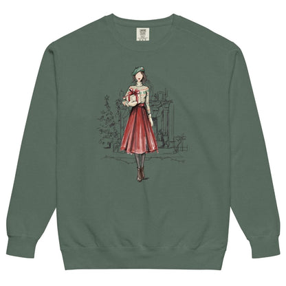 Holiday Muse™ sweatshirt by Blossombless.co in Blue Spruce, front view: a sketch-style watercolor illustration of a faceless woman in a green beret, Fair Isle sweater and red pleated skirt holding a wrapped gift, with a loosely sketched fireplace and Christmas tree behind her