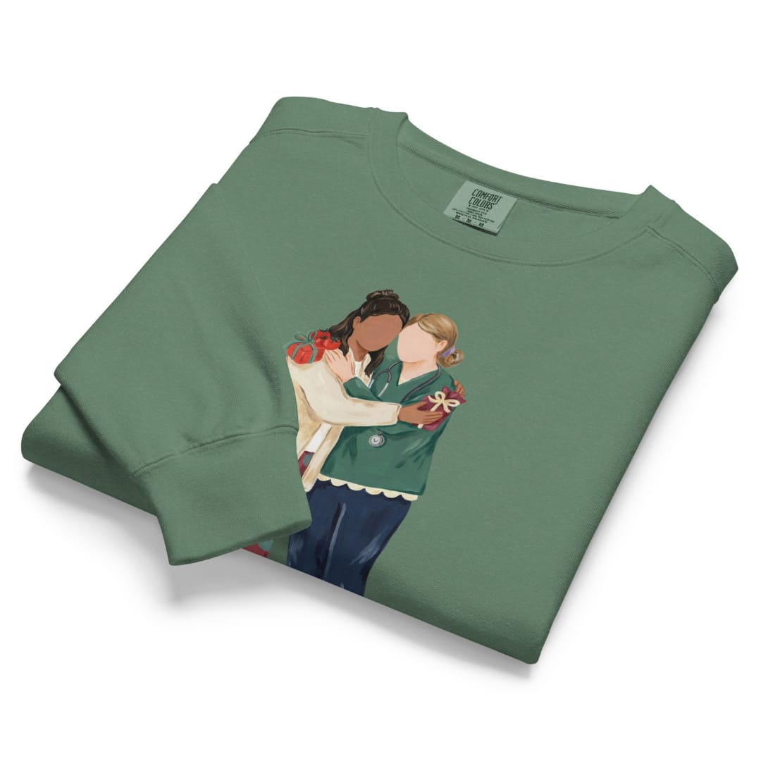 Charted With Love™ sweatshirt by Blossombless.co in Light Green, folded to show the heavyweight fleece and the painterly nurse friends graphic