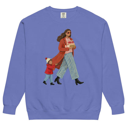Wrapped & Running™ sweatshirt by Blossombless.co in Flo Blue, front view: a mom in a long red coat and red sunglasses carrying wrapped gifts, her toddler holding the hem of her coat, in a soft gouache style