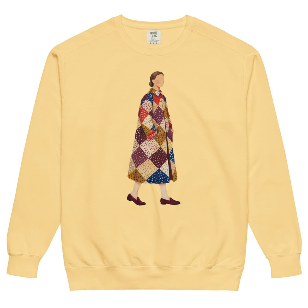Pieced Together™ sweatshirt by Blossombless.co in Butter, front view: a hand-painted faceless woman walking in an oversized patchwork coat of burgundy, mustard, cream, red and navy diamonds