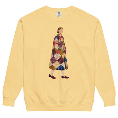 Pieced Together™ sweatshirt by Blossombless.co in Butter, front view: a hand-painted faceless woman walking in an oversized patchwork coat of burgundy, mustard, cream, red and navy diamonds