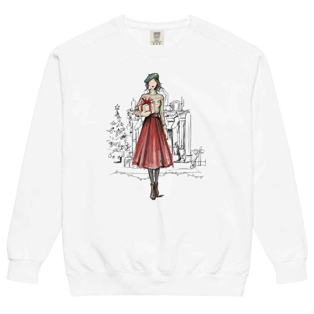 Holiday Muse™ sweatshirt by Blossombless.co in White, front view: a sketch-style watercolor illustration of a faceless woman in a green beret, Fair Isle sweater and red pleated skirt holding a wrapped gift, with a loosely sketched fireplace and Christmas tree behind her