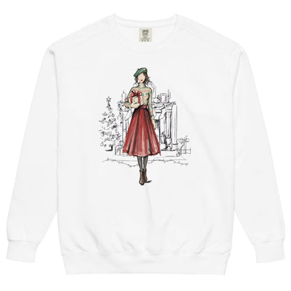 Holiday Muse™ sweatshirt by Blossombless.co in White, front view: a sketch-style watercolor illustration of a faceless woman in a green beret, Fair Isle sweater and red pleated skirt holding a wrapped gift, with a loosely sketched fireplace and Christmas tree behind her