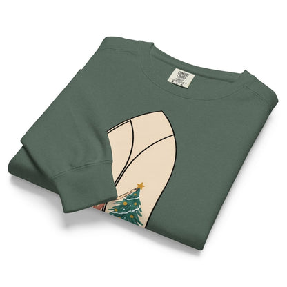 Star of the Season™ sweatshirt by Blossombless.co in Blue Spruce, neatly folded to show the garment-dyed fleece and a soft pastel illustration of a woman in a backless rose gown placing a gold star on a Christmas tree, framed inside an ivory gothic arched window