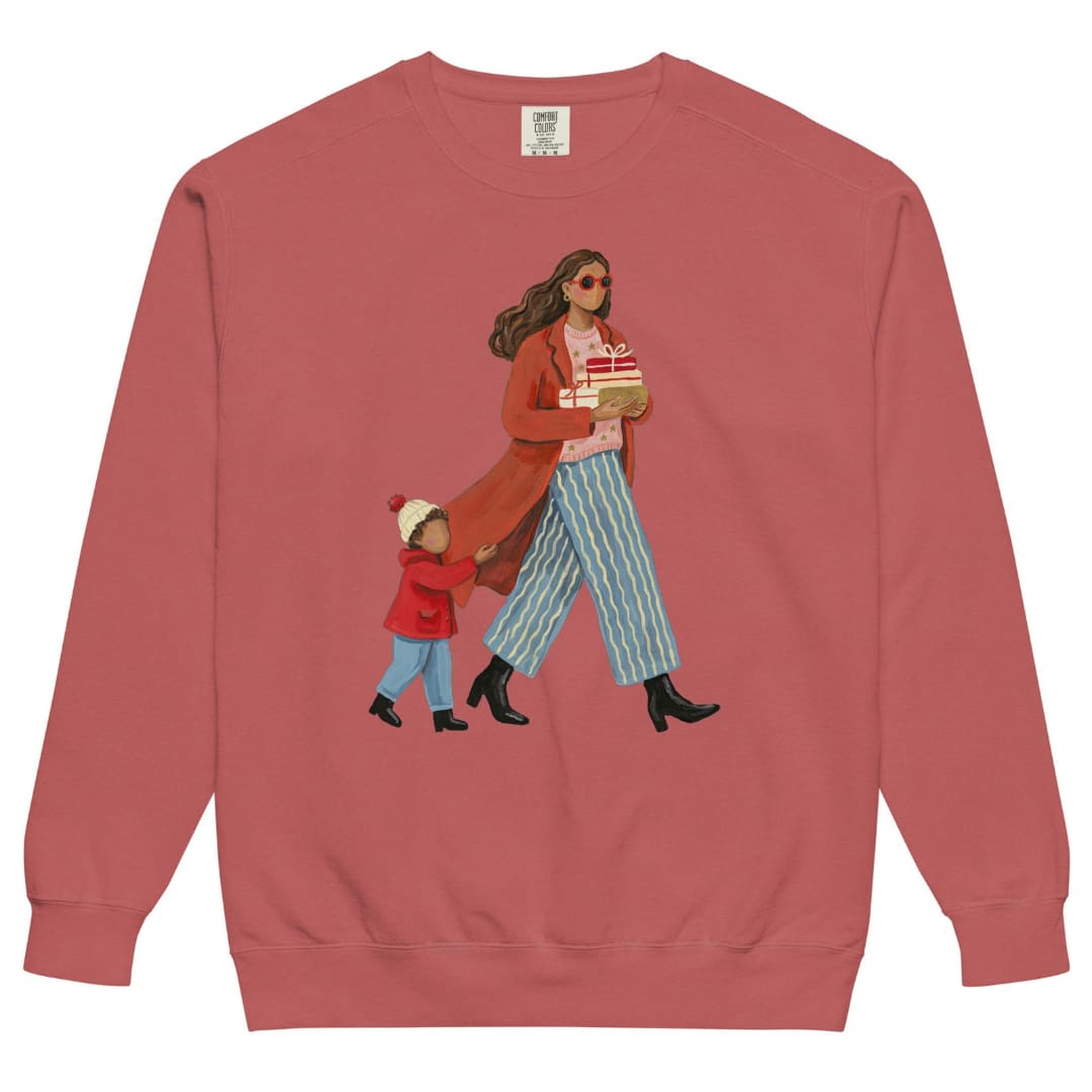 Wrapped & Running™ sweatshirt by Blossombless.co in Crimson, front view: a mom in a long red coat and red sunglasses carrying wrapped gifts, her toddler holding the hem of her coat, in a soft gouache style