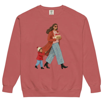 Wrapped & Running™ sweatshirt by Blossombless.co in Crimson, front view: a mom in a long red coat and red sunglasses carrying wrapped gifts, her toddler holding the hem of her coat, in a soft gouache style