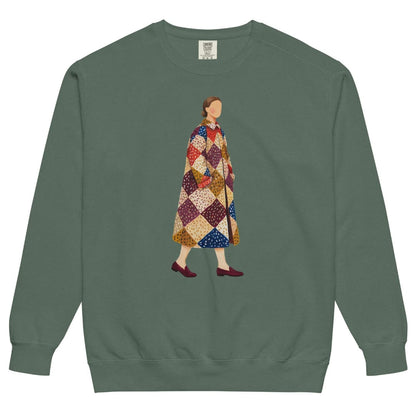 Pieced Together™ sweatshirt by Blossombless.co in Blue Spruce, front view: a hand-painted faceless woman walking in an oversized patchwork coat of burgundy, mustard, cream, red and navy diamonds