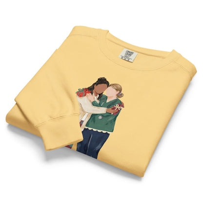 Charted With Love™ sweatshirt by Blossombless.co in Butter, folded to show the heavyweight fleece and the painterly nurse friends graphic