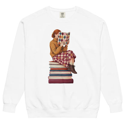 Between Chapters™ sweatshirt by Blossombless.co in White, front view: a painterly woman perched on a stack of books, her face hidden behind a harlequin hardcover