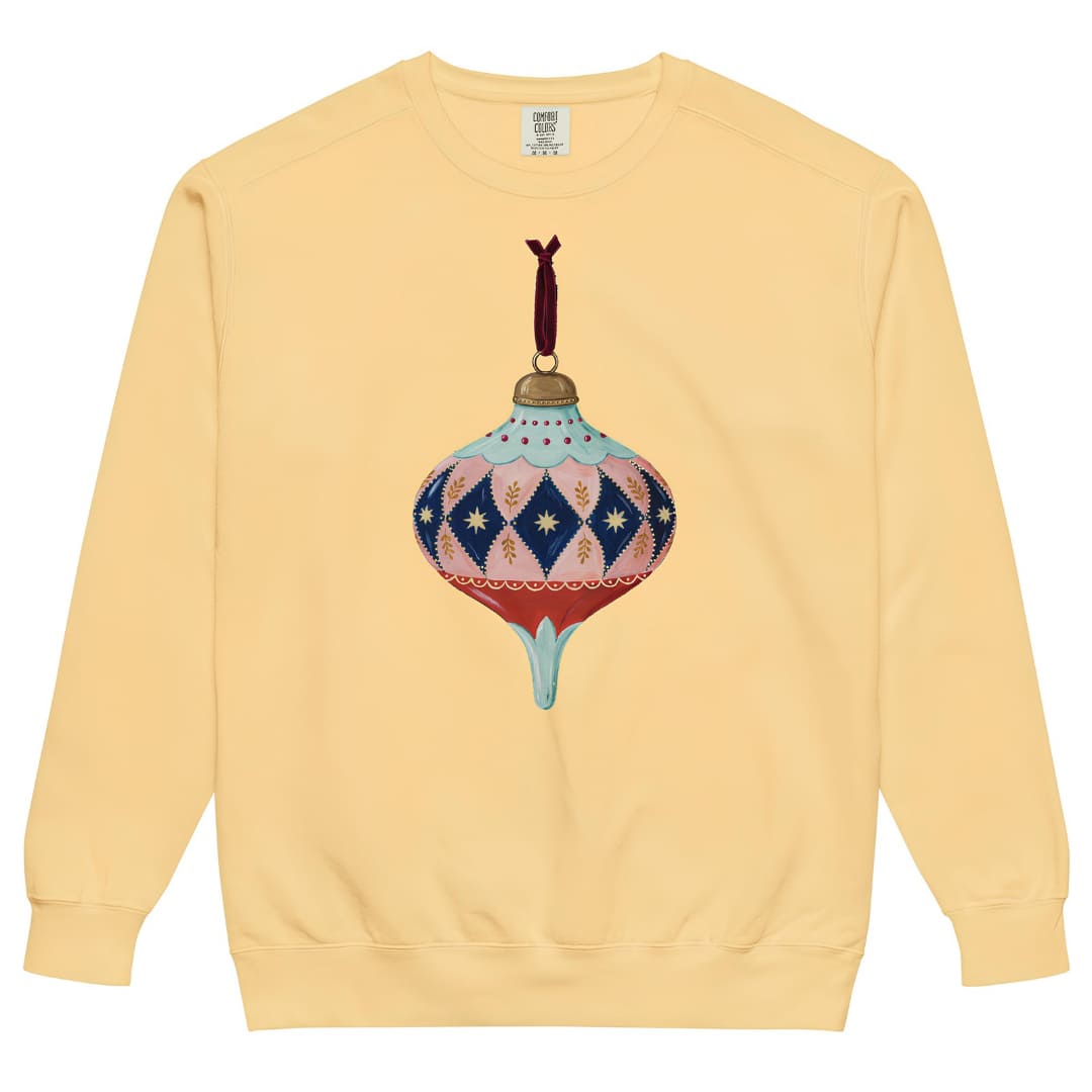 Handed Down™ sweatshirt by Blossombless.co in Butter, front view: a painterly vintage glass ornament with blush and navy harlequin diamonds, gold stars, a mint top and a red base, hung from a burgundy velvet ribbon