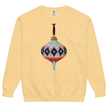 Handed Down™ sweatshirt by Blossombless.co in Butter, front view: a painterly vintage glass ornament with blush and navy harlequin diamonds, gold stars, a mint top and a red base, hung from a burgundy velvet ribbon