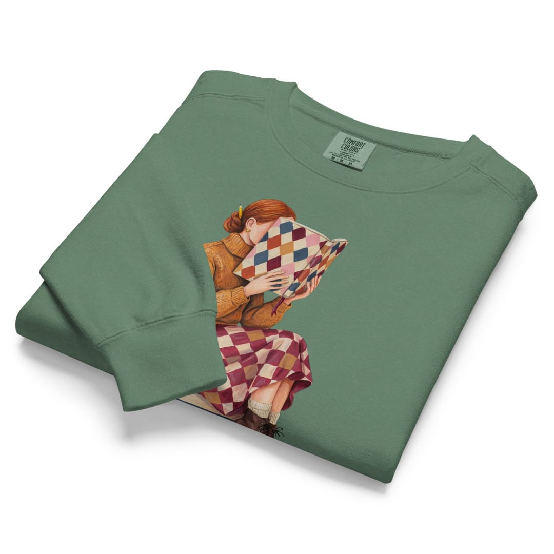 Between Chapters™ sweatshirt by Blossombless.co in Light Green, folded to show the heavyweight fleece and the painterly reading graphic