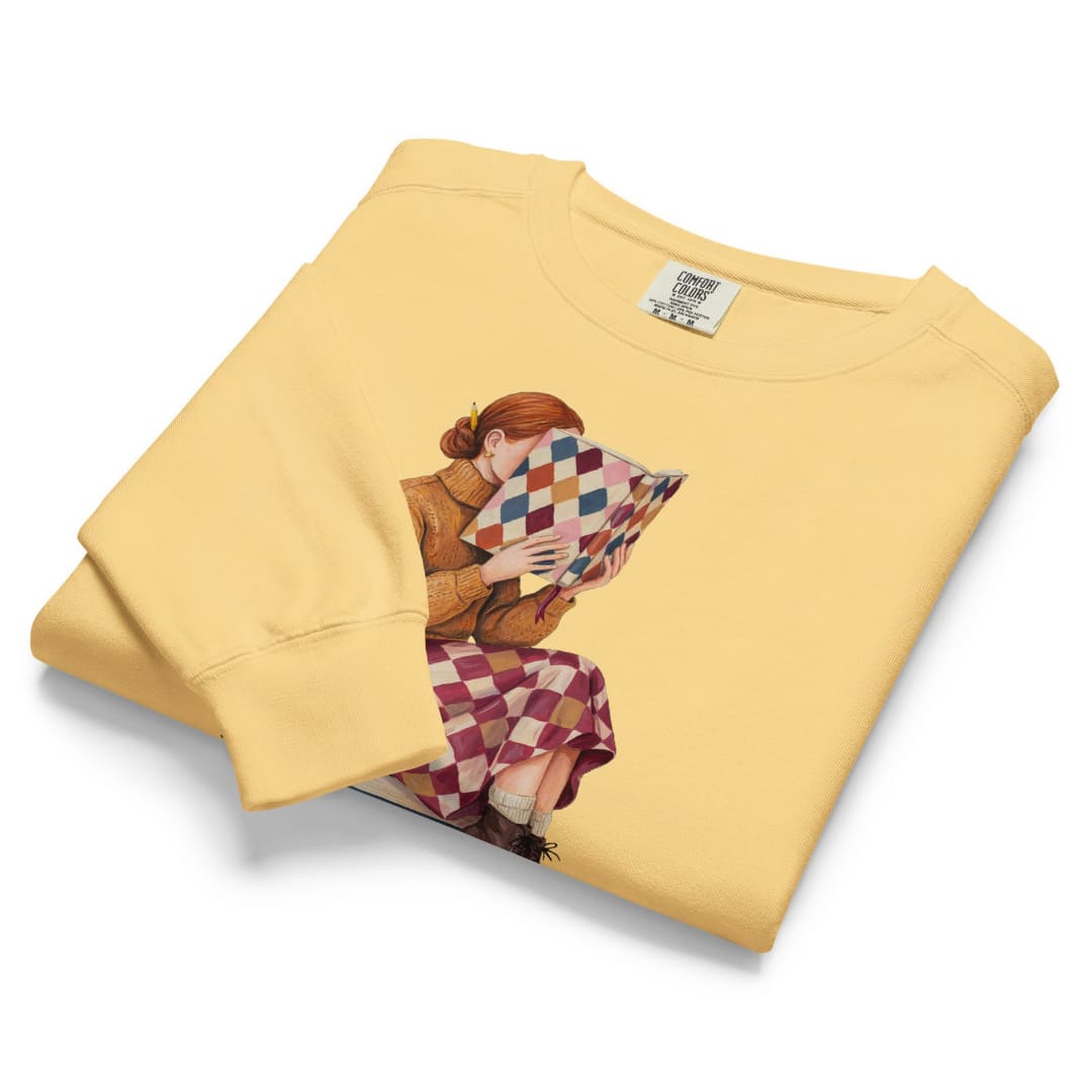 Between Chapters™ sweatshirt by Blossombless.co in Butter, folded to show the heavyweight fleece and the painterly reading graphic
