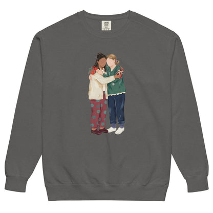 Charted With Love™ sweatshirt by Blossombless.co in Pepper, front view: two nurse friends hugging, each hiding a wrapped gift, in a soft gouache style with a stethoscope, striped compression socks and clogs