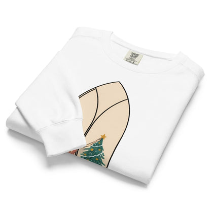 Star of the Season™ sweatshirt by Blossombless.co in White, neatly folded to show the garment-dyed fleece and a soft pastel illustration of a woman in a backless rose gown placing a gold star on a Christmas tree, framed inside an ivory gothic arched window