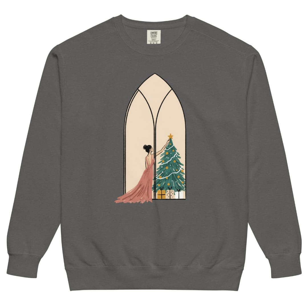 Star of the Season™ sweatshirt by Blossombless.co in Pepper, front view: a soft pastel illustration of a woman in a backless rose gown placing a gold star on a Christmas tree, framed inside an ivory gothic arched window