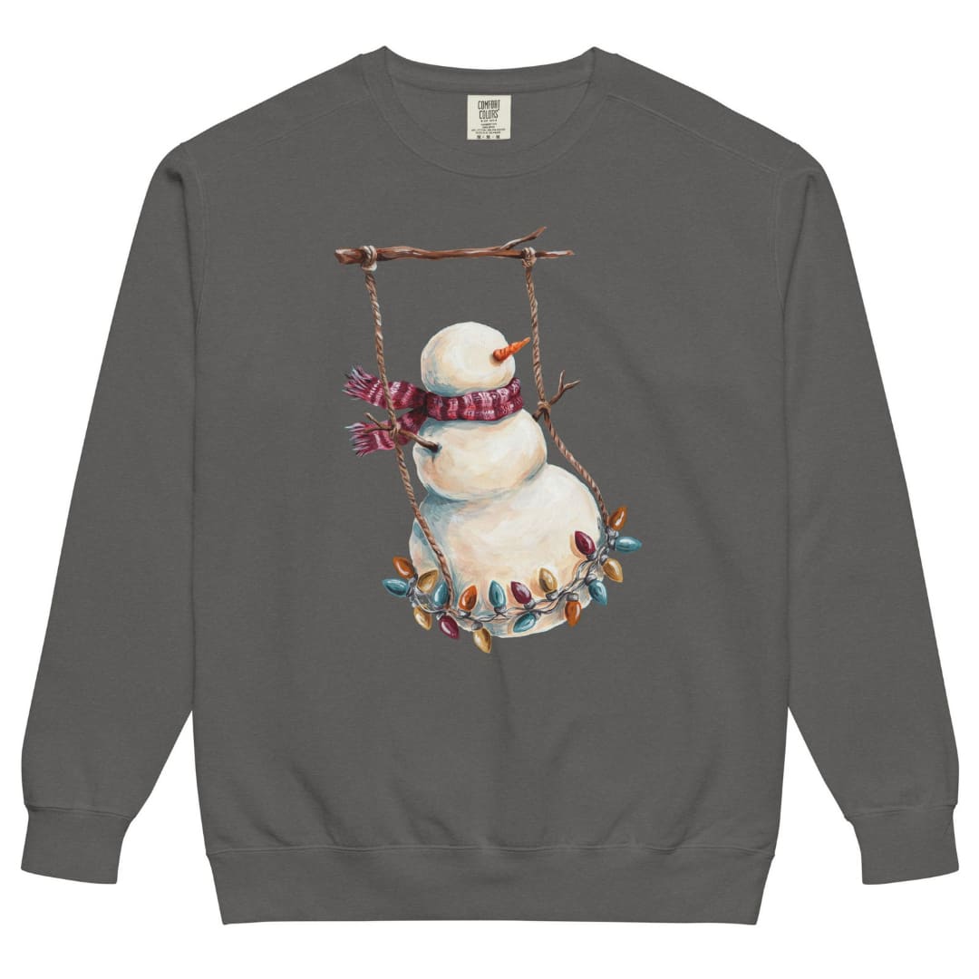 Swing Season™ sweatshirt by Blossombless.co in Pepper, front view: a painterly snowman swinging on a strand of vintage Christmas lights from a bare winter branch, wearing a striped burgundy scarf