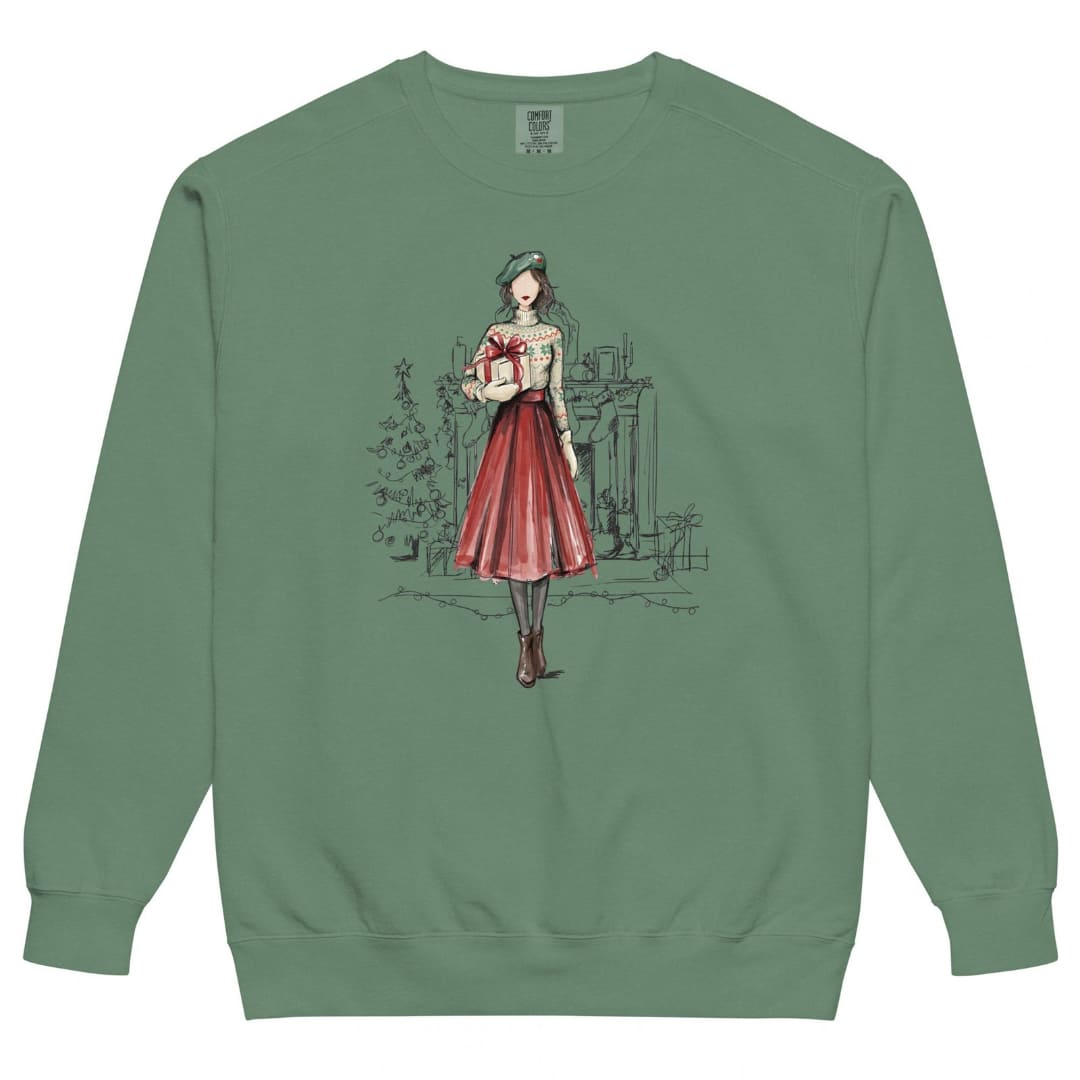 Holiday Muse™ sweatshirt by Blossombless.co in Light Green, front view: a sketch-style watercolor illustration of a faceless woman in a green beret, Fair Isle sweater and red pleated skirt holding a wrapped gift, with a loosely sketched fireplace and Christmas tree behind her