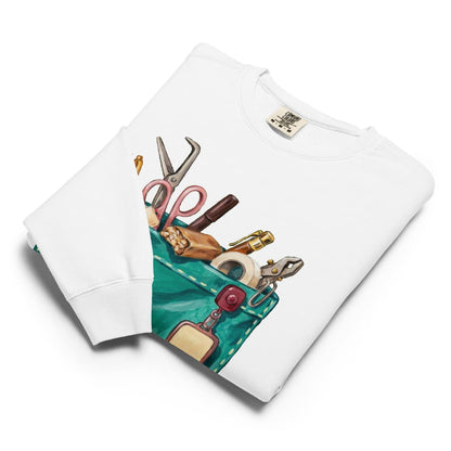 The Shift Pocket™ sweatshirt in White, folded flat with the hand-painted scrub pocket design on the chest