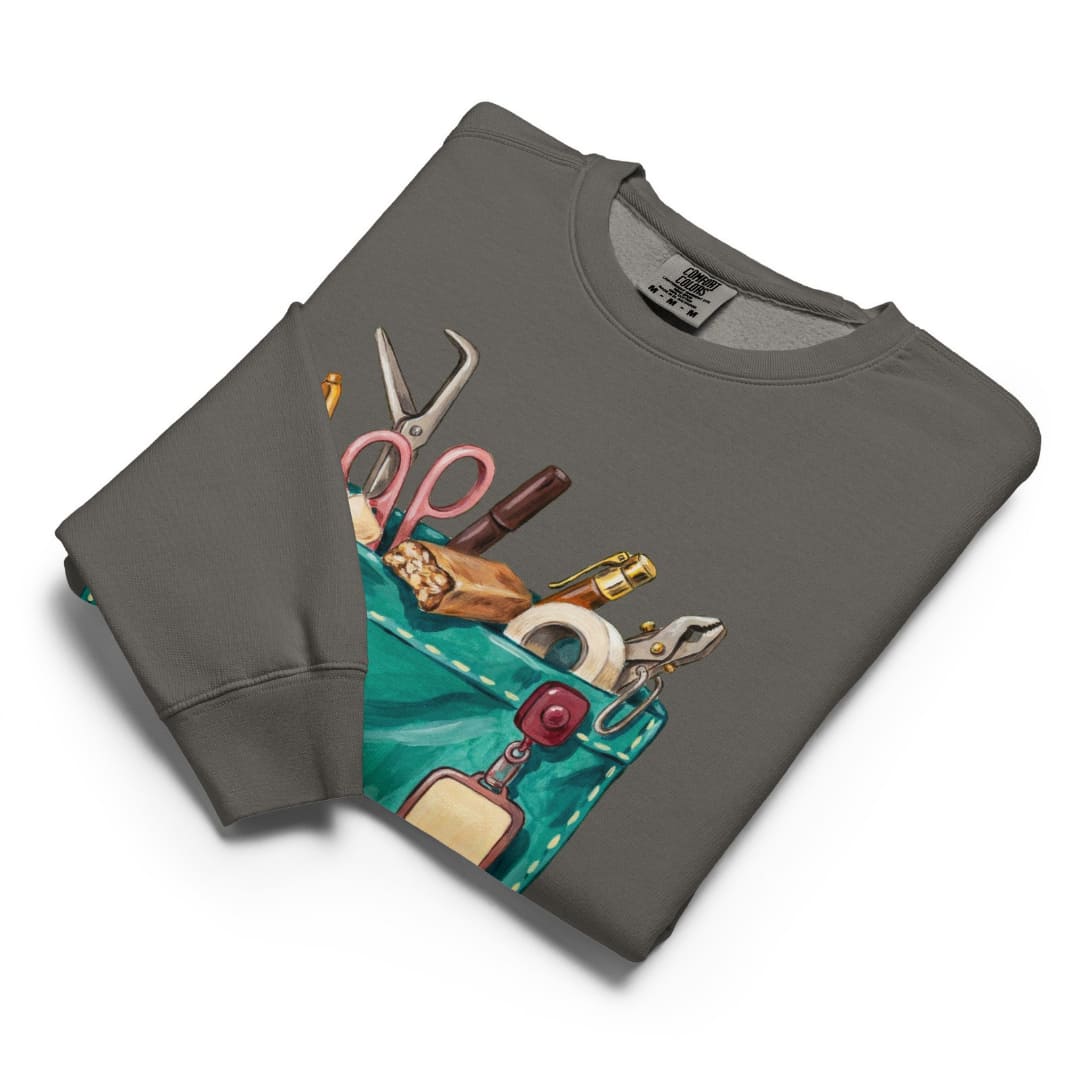 The Shift Pocket™ sweatshirt in Pepper, folded flat with the hand-painted scrub pocket design on the chest
