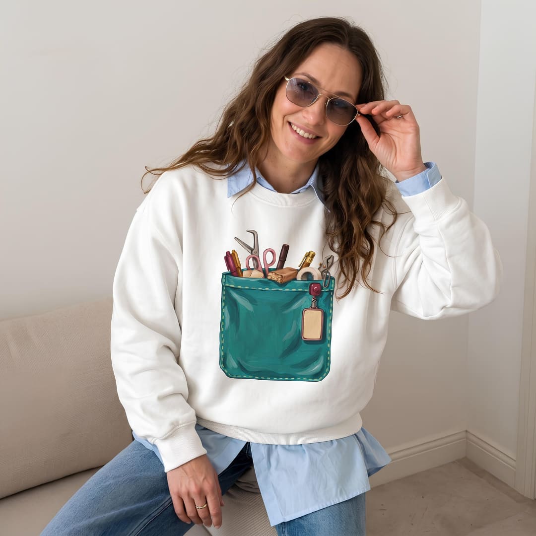 Woman wearing The Shift Pocket™ sweatshirt in White, layered over a light blue shirt with jeans and sunglasses