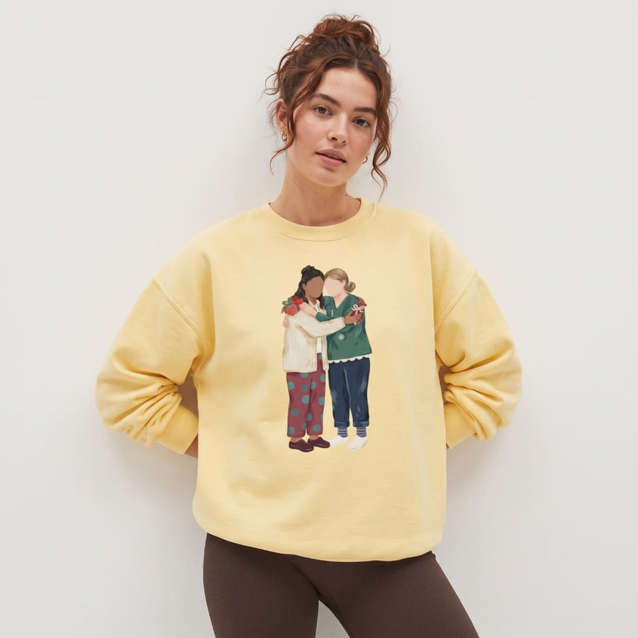 Woman wearing the Charted With Love™ sweatshirt by Blossombless.co in Butter with dark trousers, standing against a white wall