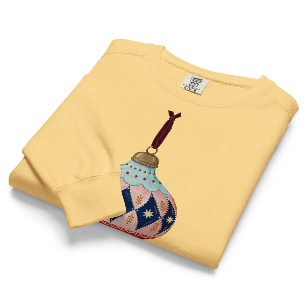 Handed Down™ sweatshirt by Blossombless.co in Butter, folded to show the heavyweight fleece and the vintage ornament graphic