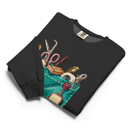 The Shift Pocket™ sweatshirt in Black, folded flat with the hand-painted scrub pocket design on the chest