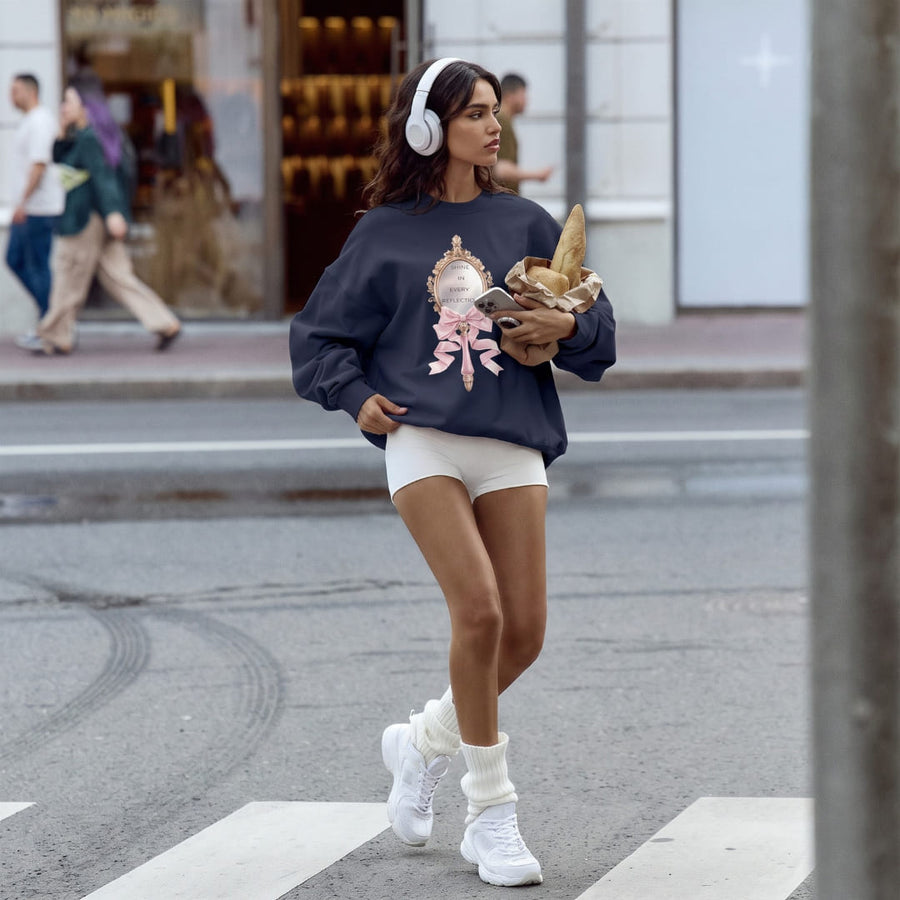 Shine in Reflection™ oversized sweatshirt by Blossombless.co in Navy, lifestyle: woman in white shorts and headphones crossing a city street