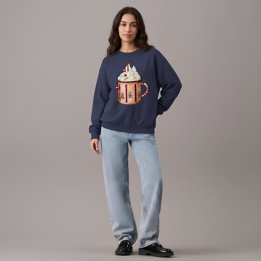 Woman wearing the Après Cocoa™ sweatshirt by Blossombless.co in True Navy with light-wash wide-leg jeans and black loafers, gray studio backdrop
