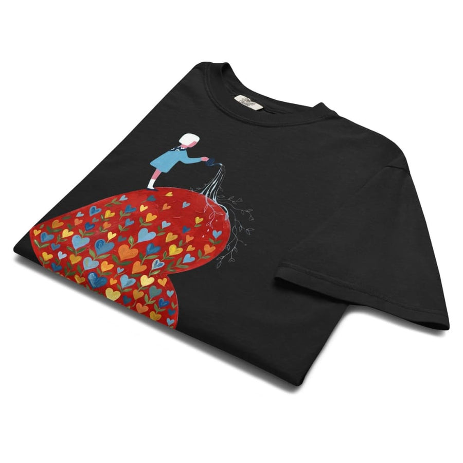 Black t-shirt with a colorful heart design and character on a white background